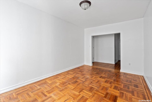 unfurnished room featuring parquet flooring