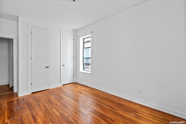 unfurnished bedroom with wood-type flooring