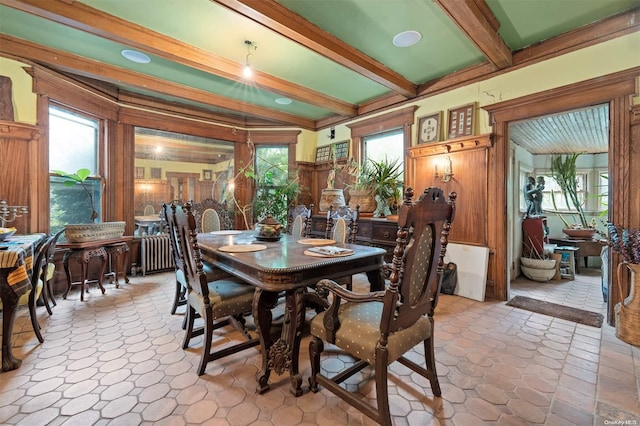 dining space with beam ceiling