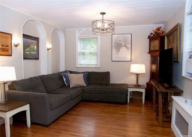 living room with crown molding, hardwood / wood-style floors, wood ceiling, and an inviting chandelier