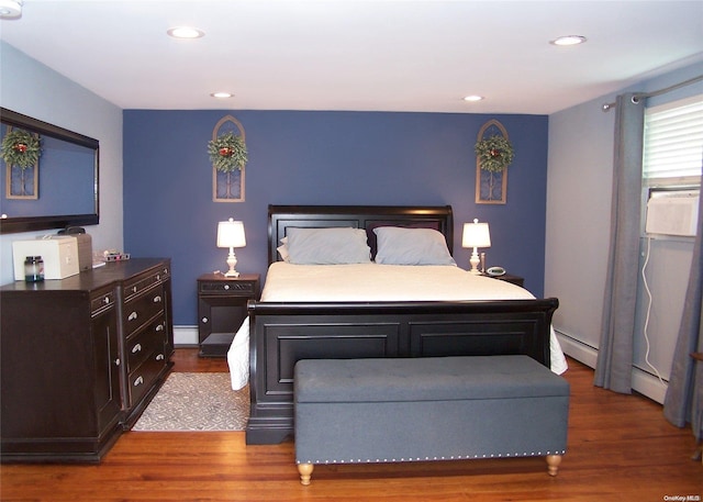 bedroom featuring dark hardwood / wood-style flooring and a baseboard radiator