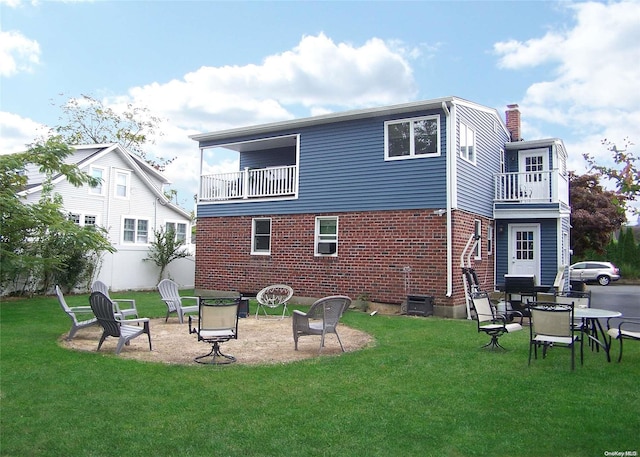 back of house featuring a balcony, a yard, and a patio