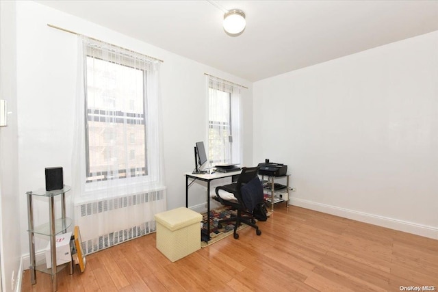 home office featuring radiator and hardwood / wood-style floors