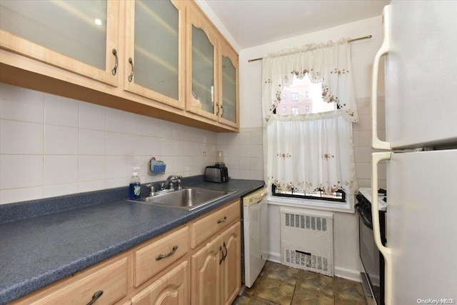 kitchen with radiator, sink, light brown cabinets, tasteful backsplash, and white appliances