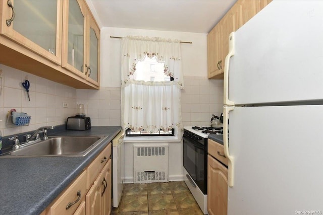 kitchen with backsplash, radiator heating unit, white appliances, and sink