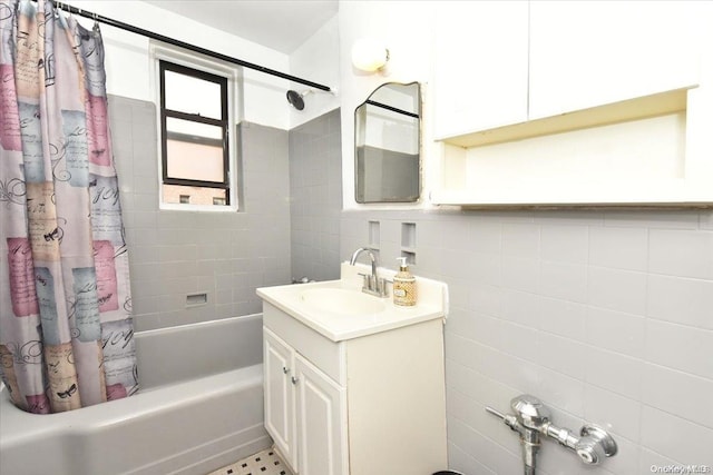 bathroom with shower / bath combo, tile walls, and vanity