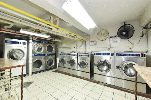 clothes washing area featuring a textured ceiling, separate washer and dryer, stacked washer / dryer, and light tile patterned floors