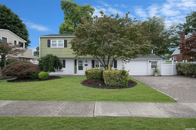 view of front of house with a front lawn and a garage