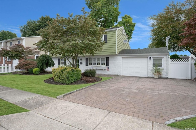 view of front facade with a garage and a front yard