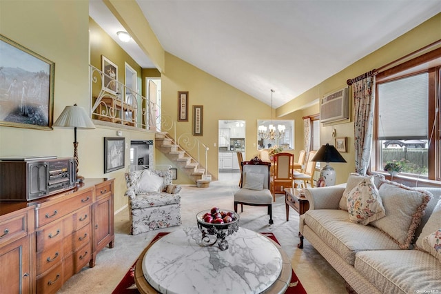 carpeted living room with high vaulted ceiling, a wall mounted AC, and a notable chandelier