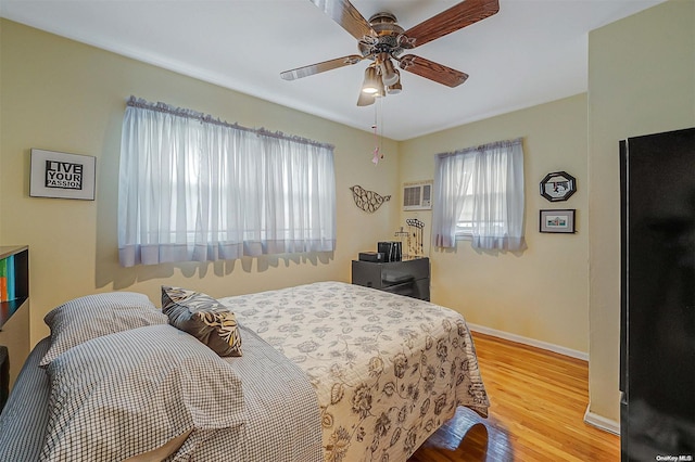 bedroom with light hardwood / wood-style floors and ceiling fan