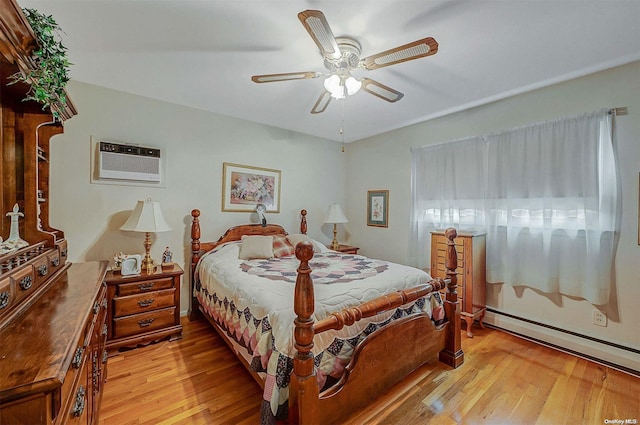 bedroom featuring light wood-type flooring, baseboard heating, an AC wall unit, and ceiling fan