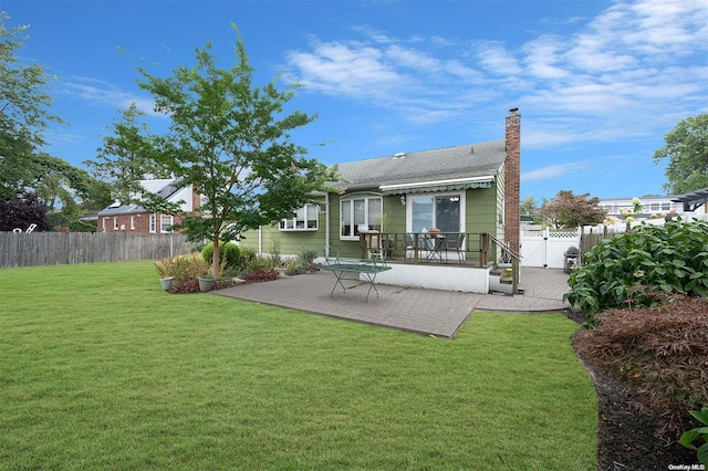 rear view of house featuring a patio area and a yard