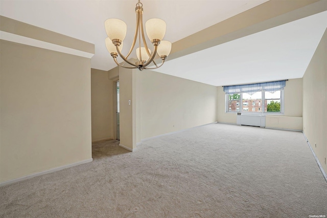 spare room with light carpet and a chandelier