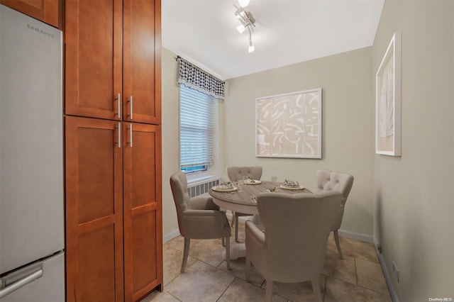 dining space featuring light tile patterned floors