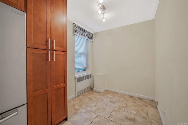 kitchen featuring radiator heating unit and white fridge