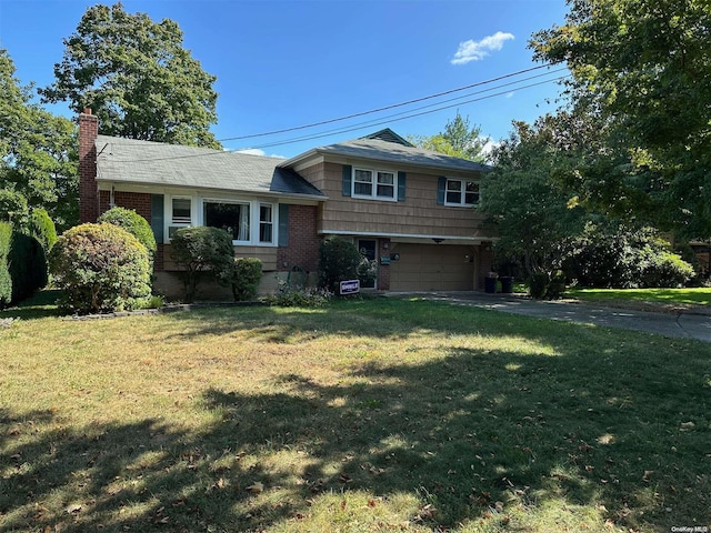 view of front of home with a garage and a front lawn