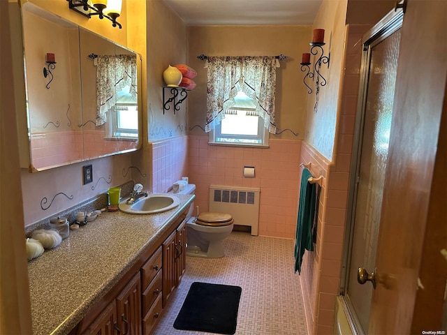 bathroom with tile patterned floors, plenty of natural light, tile walls, and radiator