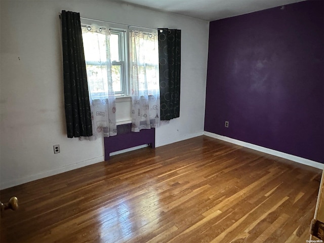 spare room with hardwood / wood-style flooring