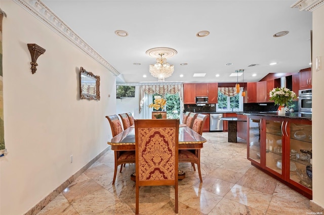 dining room featuring ornamental molding and a chandelier