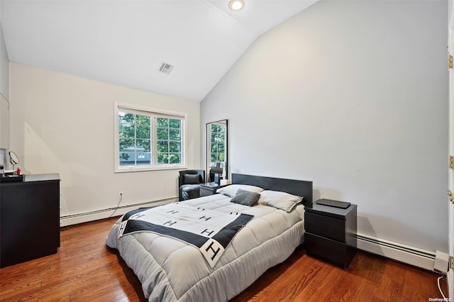 bedroom featuring wood-type flooring, vaulted ceiling, and a baseboard heating unit