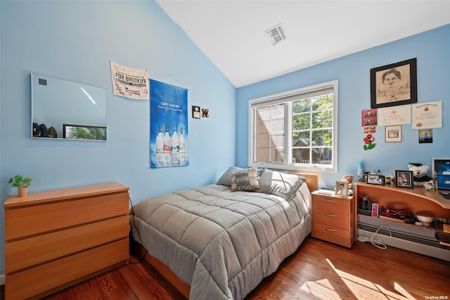 bedroom with dark hardwood / wood-style flooring and vaulted ceiling