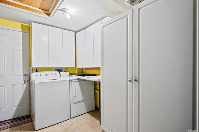 washroom featuring light tile patterned floors, cabinets, and independent washer and dryer