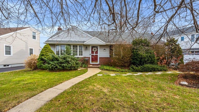 bungalow-style home featuring a front yard