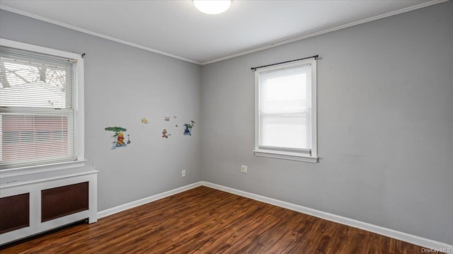 empty room featuring dark hardwood / wood-style flooring and crown molding