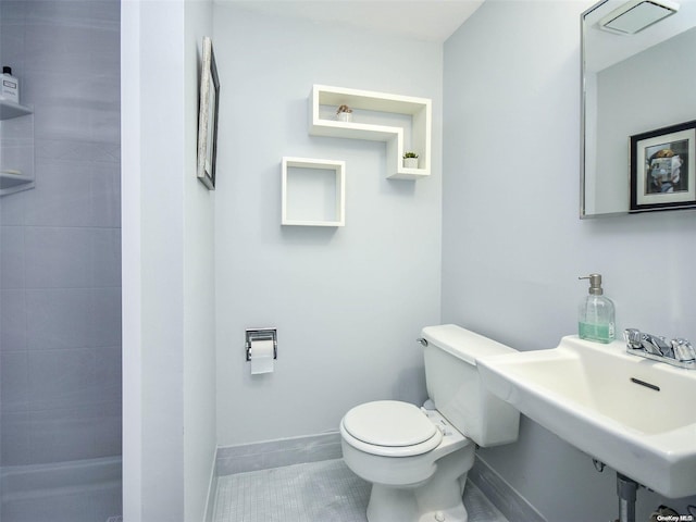 bathroom featuring tile patterned floors, toilet, and sink