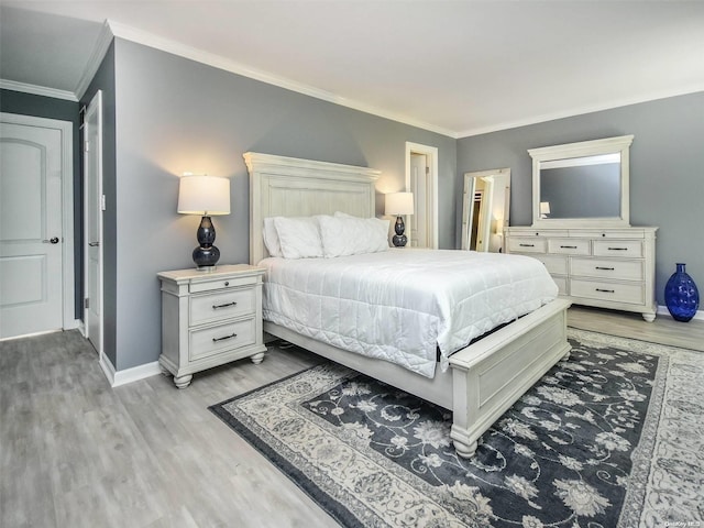 bedroom with light hardwood / wood-style floors and crown molding