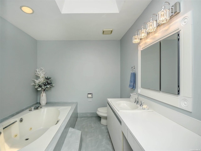 bathroom featuring a skylight, tile patterned floors, tiled bath, toilet, and vanity