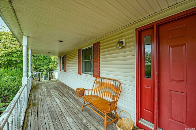 wooden terrace featuring covered porch