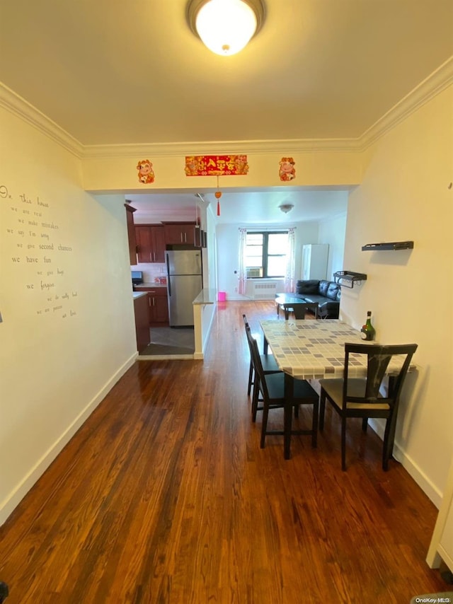 dining area featuring dark hardwood / wood-style floors and ornamental molding