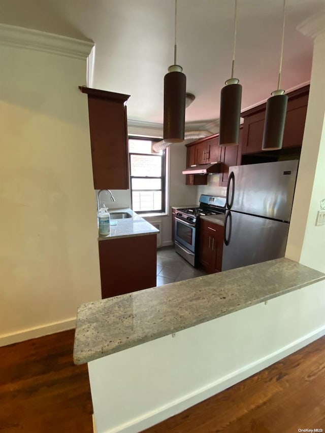 kitchen featuring sink, dark hardwood / wood-style floors, decorative light fixtures, kitchen peninsula, and stainless steel appliances