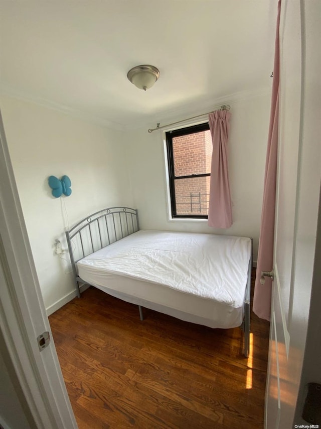 bedroom with dark wood-type flooring