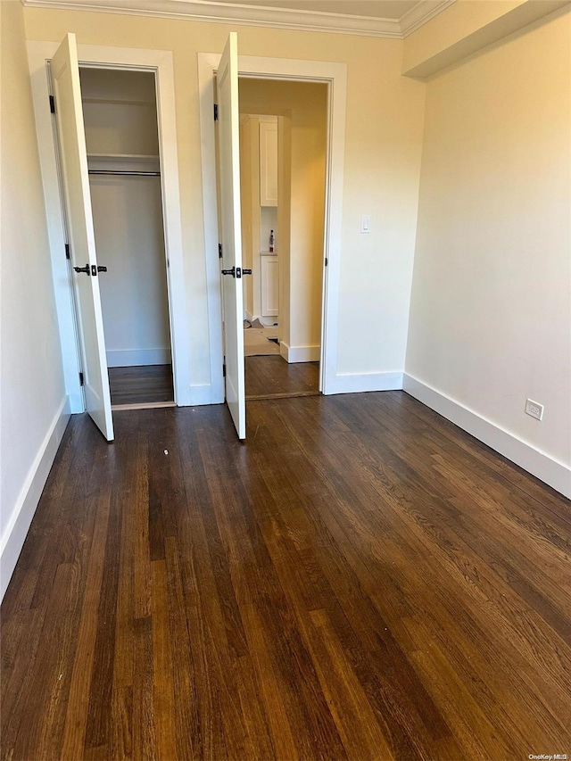 150-25 72nd Rd Unit 4A, Flushing, NY 11367 - unfurnished bedroom featuring crown molding, baseboards, dark wood finished floors, and a closet