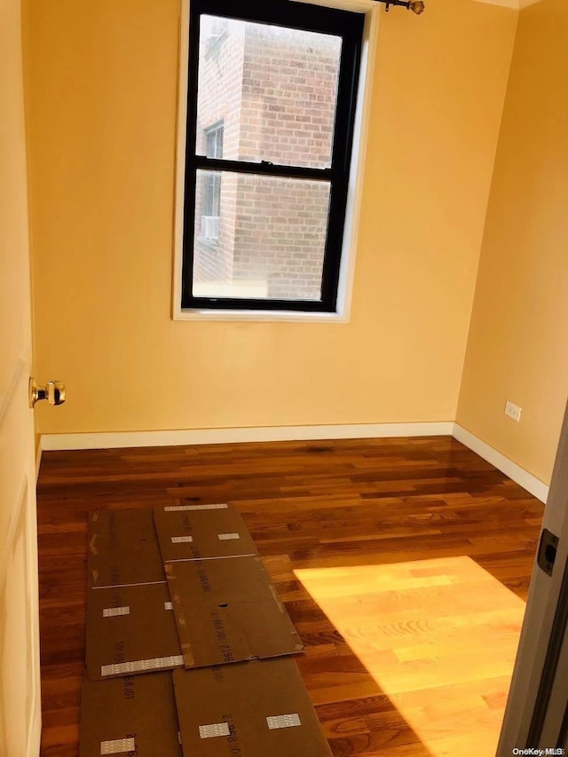 spare room with hardwood / wood-style floors