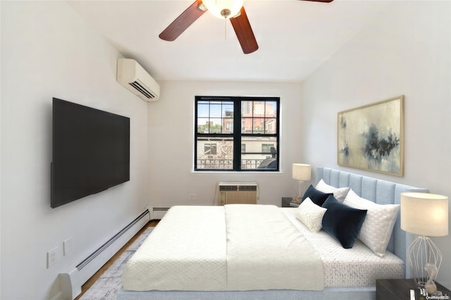 bedroom featuring a wall unit AC, wood finished floors, a ceiling fan, a wall mounted air conditioner, and baseboard heating