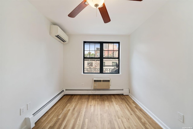 spare room featuring a wall unit AC, baseboards, an AC wall unit, light wood-style floors, and a baseboard heating unit