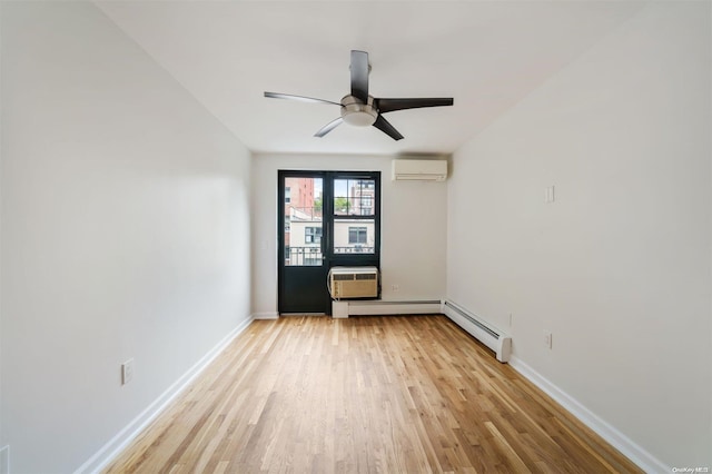 spare room with light wood-style floors, baseboards, and a wall mounted air conditioner