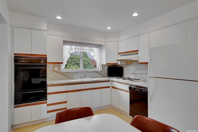 kitchen featuring white appliances, tasteful backsplash, and white cabinetry