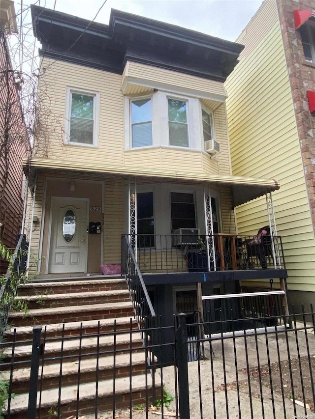 view of front of house with covered porch and cooling unit