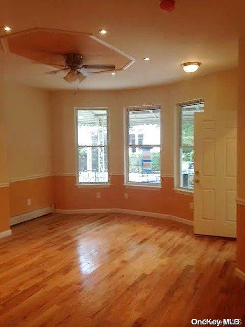 unfurnished room featuring ceiling fan and light hardwood / wood-style flooring