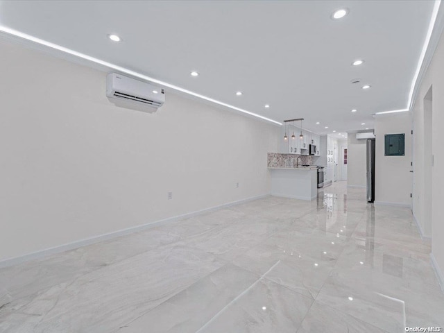 unfurnished living room featuring electric panel and a wall mounted AC