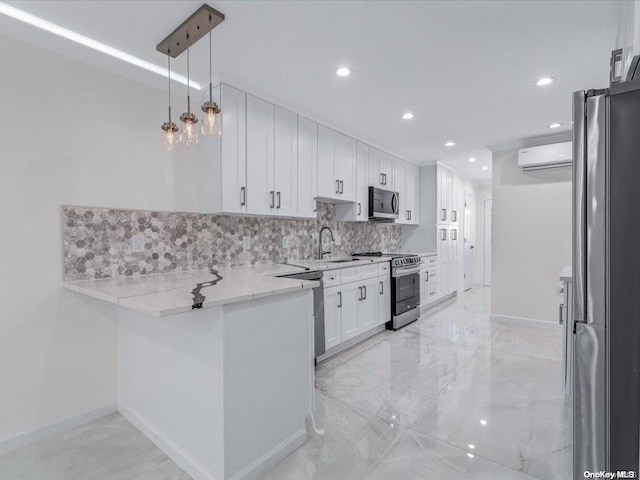 kitchen with white cabinetry, hanging light fixtures, stainless steel appliances, an AC wall unit, and kitchen peninsula