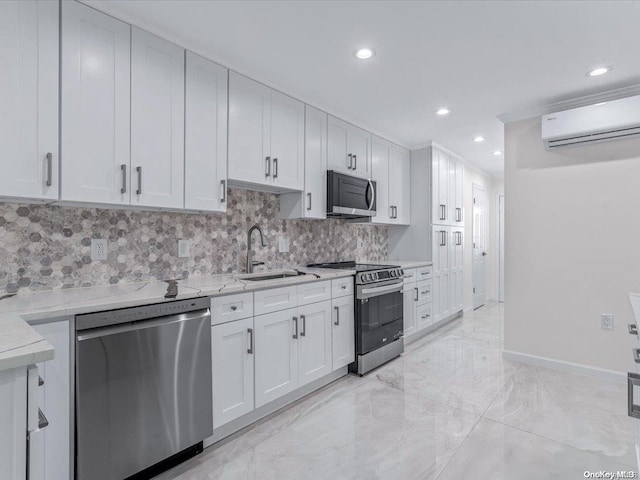 kitchen featuring appliances with stainless steel finishes, backsplash, white cabinetry, and an AC wall unit