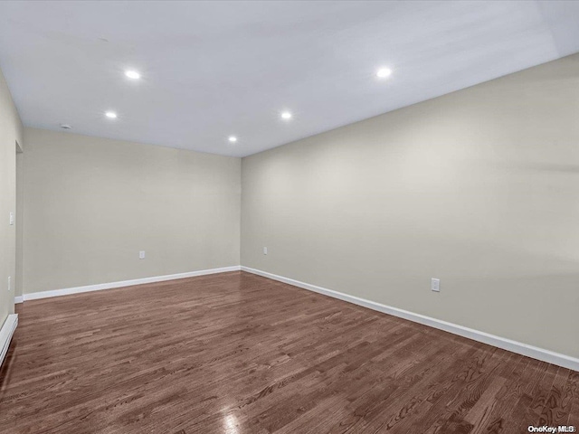 spare room featuring dark hardwood / wood-style flooring