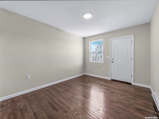 spare room featuring dark hardwood / wood-style flooring