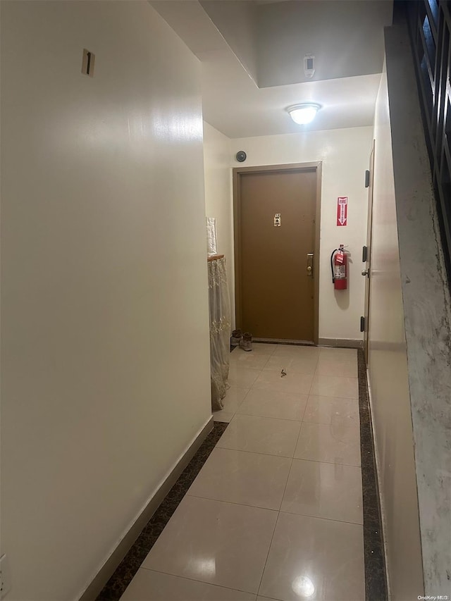 hallway featuring light tile patterned floors